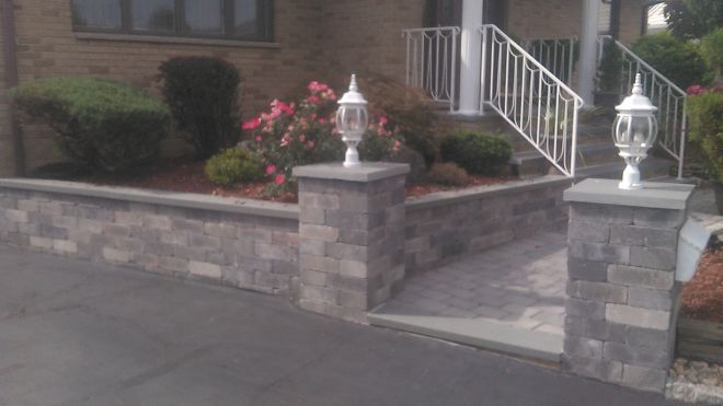 cultured stone retaining wall with paver walkway